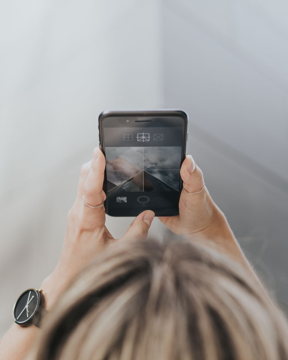 Photo of woman using Geometry Club app on iPhone