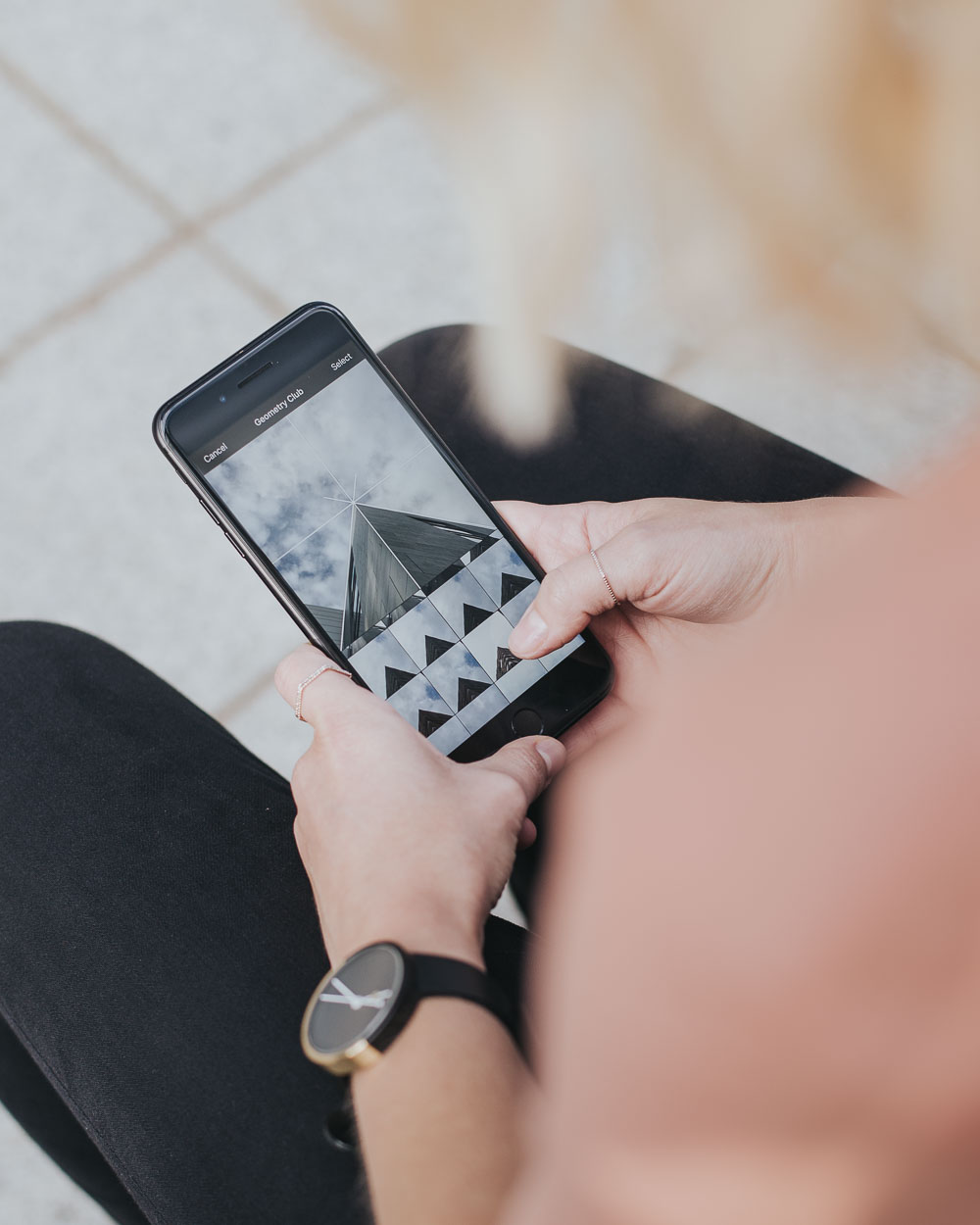 Photo of woman using Geometry Club app on iPhone